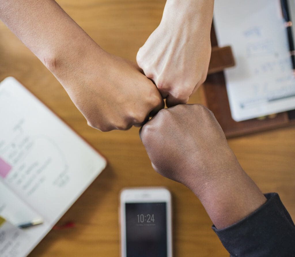 people giving a fist bump